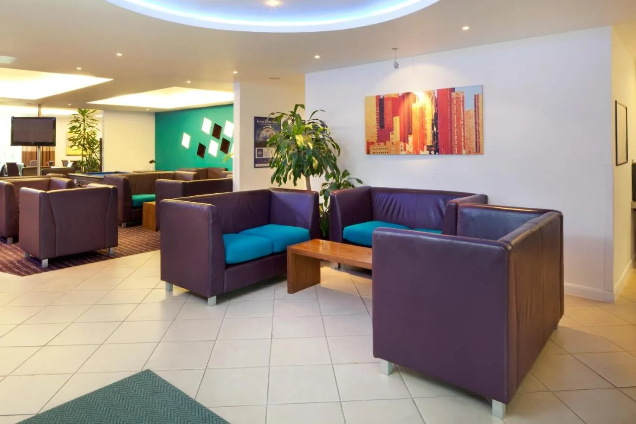 a waiting room with couches and a table at Holiday Inn Express Cambridge by IHG in Cambridge